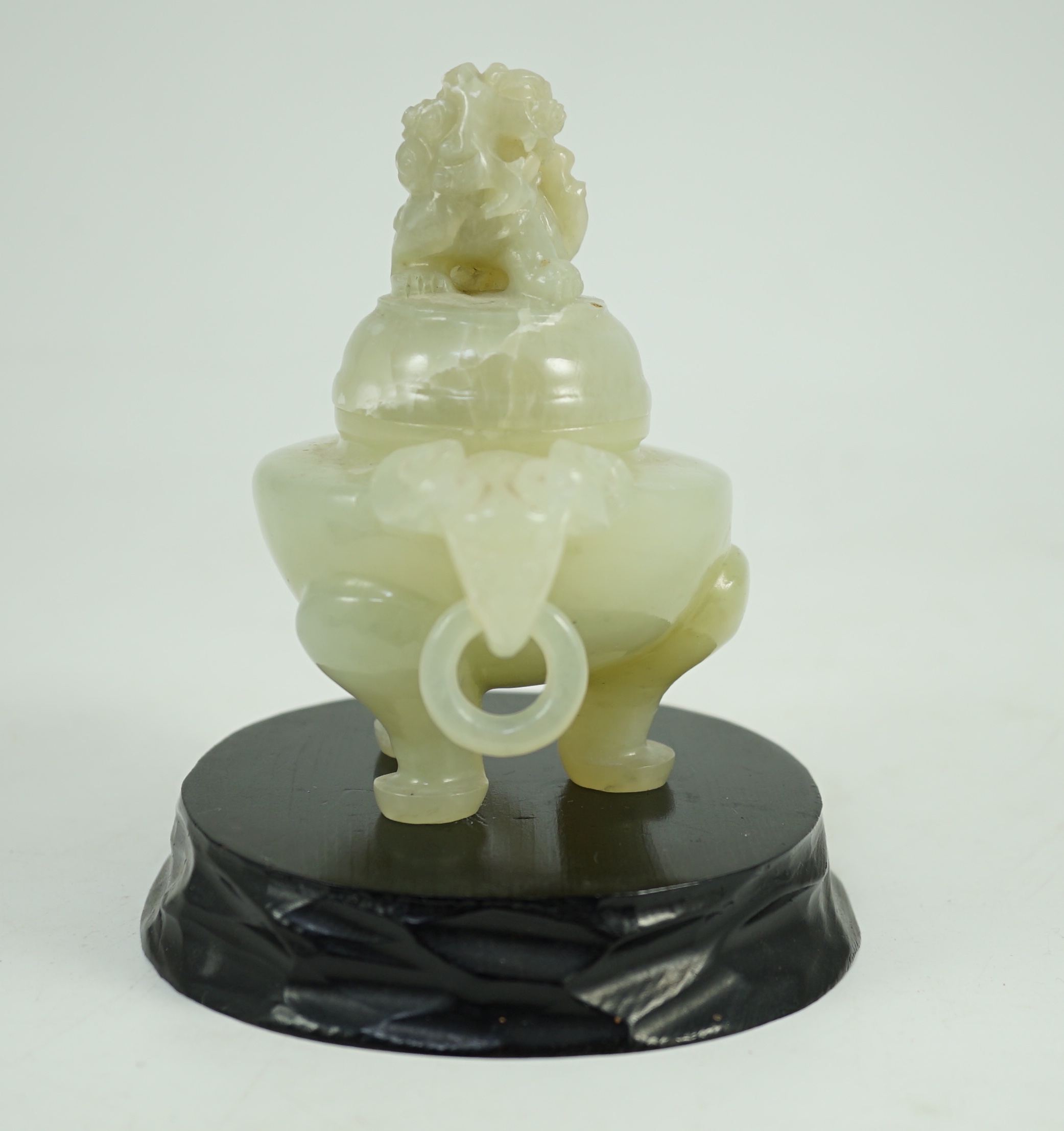 A Chinese pale celadon jade tripod censer cover, 20th century, 12cm wide, wood stand